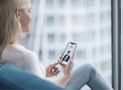 a woman smiling at a mobile